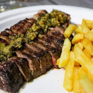 a steak and french fries on a plate
