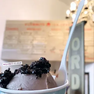 a hand holding a cup of ice cream