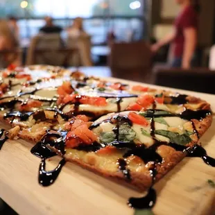 a pizza on a cutting board