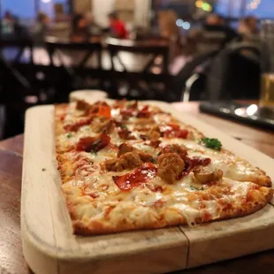 a pizza on a cutting board