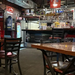 Fantastic bar with two actual front ends of a classic Caddy and I think a Plymouth. The booths are old bench seats.