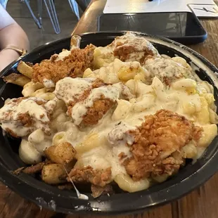 Chicken tender bowl (Mac n cheese, chicken tender pieces, fries). Comes with two sauces of your choice.  This one had ranch.