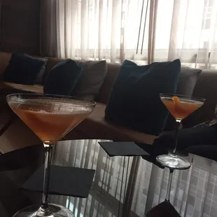 two cocktails on a glass table