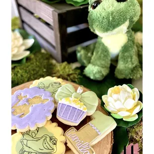 The princess and the frog bayou backdrop adventure birthday party theme Tiana 1st first kids party ideas set up dessert custom iced cookies