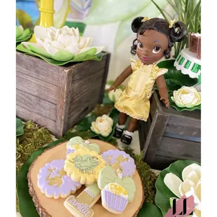 The princess and the frog bayou backdrop adventure birthday party theme Tiana 1st first kids party ideas set up dessert iced sugar cookies
