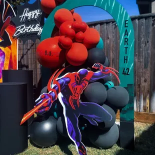 Across the Spider-Verse birthday party backdrop set up custom art miles Morales 2099 earth 42 theme kids party ideas hollow arch plinths