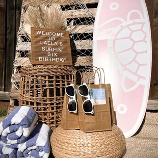 surf theme birthday party 6th sixth surfin&apos; six surfboard shades beach party favors fish netting wicker drum straw pouf cushion rattan