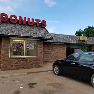 a car parked in front of a donut shop