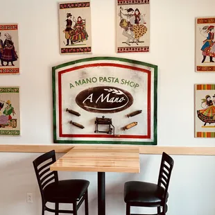 Seating just inside the door. Decor features vintage cooking tools and artwork made from authentic Polish linen kitchen towels.