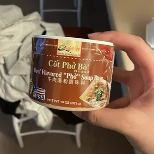 a person holding a can of food