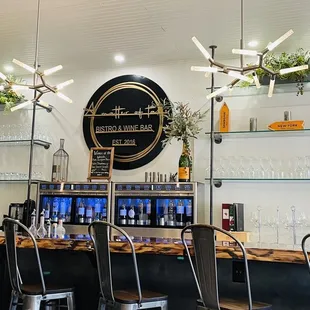 a bar with chairs and shelves