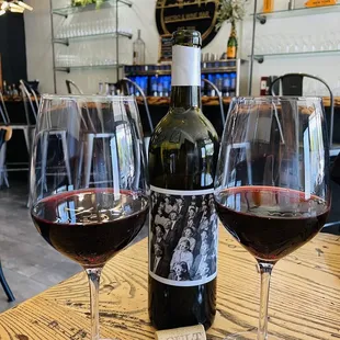 a bottle of wine and two glasses of wine
