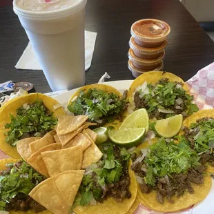 a plate of tacos and a drink