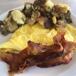"Hash browns" (home fries), 2 scrambled eggs, and bacon.