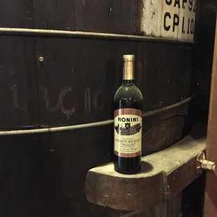 a bottle of wine on a barrel