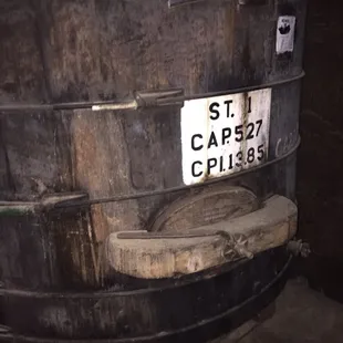a wooden barrel with a sign on it