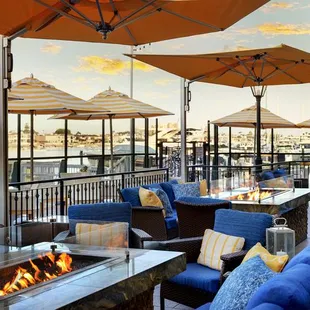 Outside patio featuring fire pits and waterfront dining