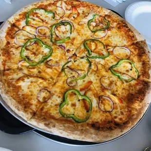 Chicken Tikka pizza with extra toppings of onion and bell pepers