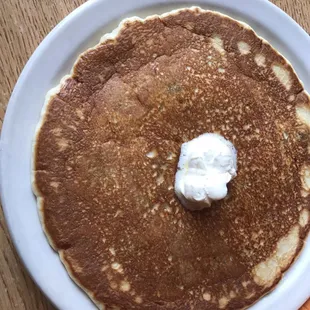 a plate of pancakes with whipped cream