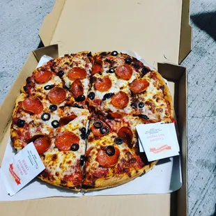 a pizza with pepperoni and olives