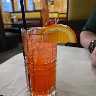 a tall glass of orange juice