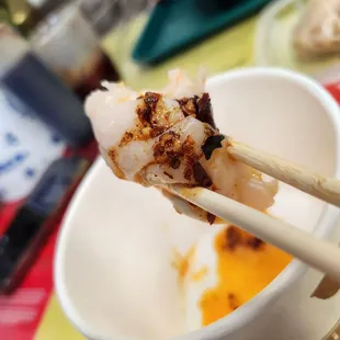 Shrimp Dumplings dipped in chili oil