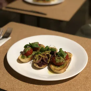 Vegan Starter: Bruschette: roasted tomato and pesto; olive tapenade, fresh olives &amp; lemon zest