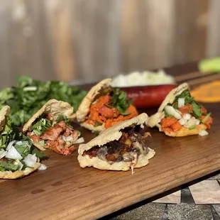 three tacos on a cutting board