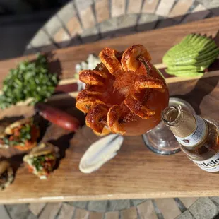 a plate of food and a bottle of beer