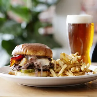 a plate of food and a glass of beer