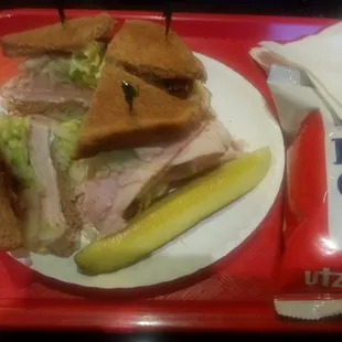 Turkey Clubon wheat with mayo, lettuce, swiss cheese and onions with a pickle and chips. Its always a huge sandwich.