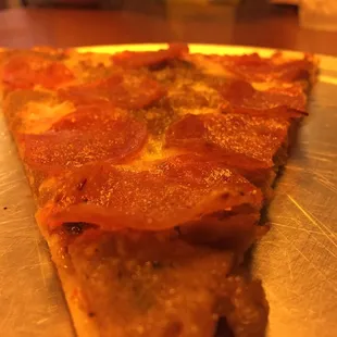 A slice of The Manhattan pizza