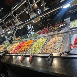 Salad bar on back side fruit stations in front