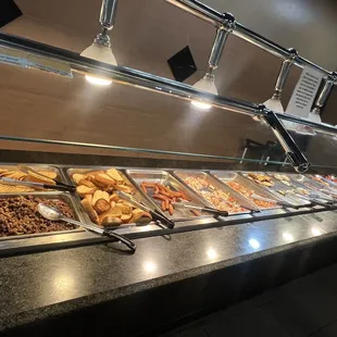 Taco station with pizza and miscellaneous cooked foods