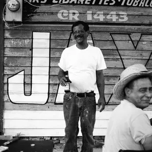 Wonderful fellows hanging about outside the bar, drinking some beers and painting a sign. Loved them.