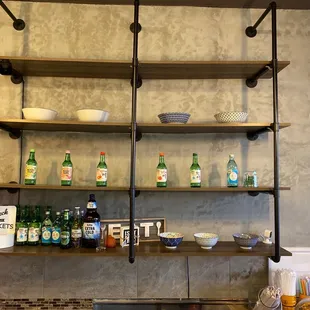 a shelf with bottles and bowls