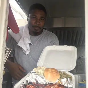 a man holding a tray of food