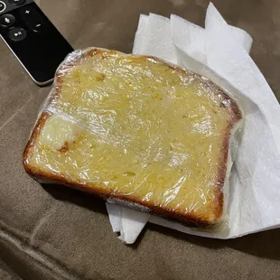 a piece of bread and a remote control