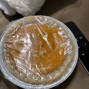 a pie covered in plastic wrap