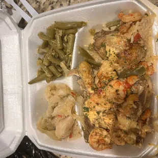 Baked chicken and shrimp loaded over dirty rice, cabbage, green beans