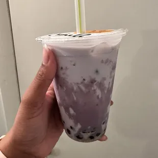 a hand holding a cup