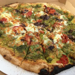 Cilantro pesto, oven dried tomato, chili sauce pizza.