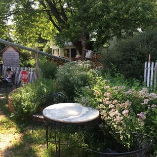 a table and chairs in a garden