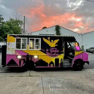 a pink and yellow food truck