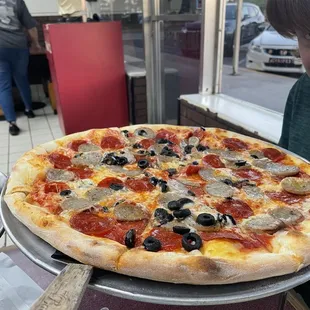 Medium pizza with black olives, sausage, and pepperoni