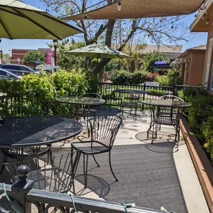 a patio with tables and chairs