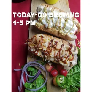 two hot dogs with toppings on a cutting board