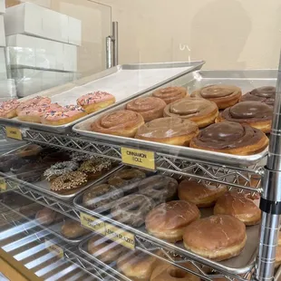 a variety of doughnuts in a display case