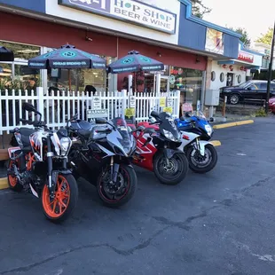 a row of motorcycles parked in front of a store