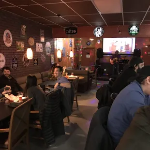 people sitting at tables in a restaurant